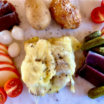 Raclette Served with Baked Potatoes, Bundnerfleish, Gherkins, Pickled Onions, Apple and Tomatoes