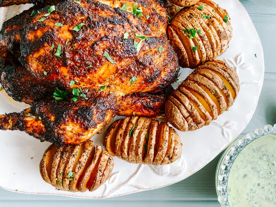 Photograph Skillet Roast Peri Peri Chicken with Coriander and Chilli Yoghurt and Hasselback Potatoes