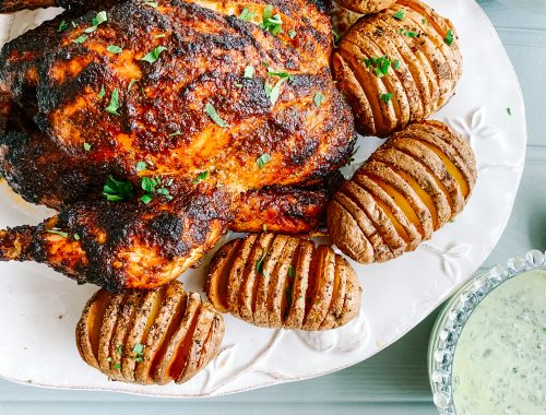 Photograph Skillet Roast Peri Peri Chicken with Coriander and Chilli Yoghurt and Hasselback Potatoes