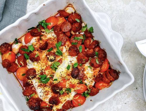 Photograph of Smoked Paprika Baked Hake with Chorizo, Lemon, Tomatoes and Garlic