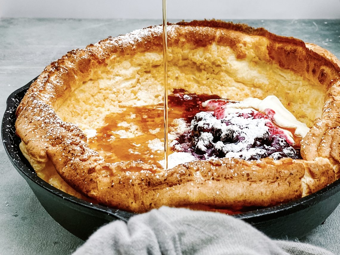 Photograph of German Pancake with Blueberry Compote, Natural Yoghurt and Maple Syrup