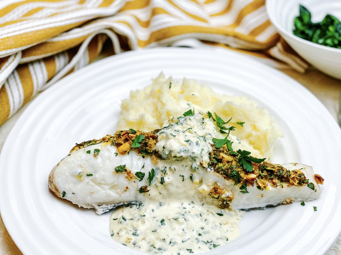 Photograph of Halibut Fillets Coated with Crispy Pistachio and Served with a Creamy Lemon and Parsley Sauce