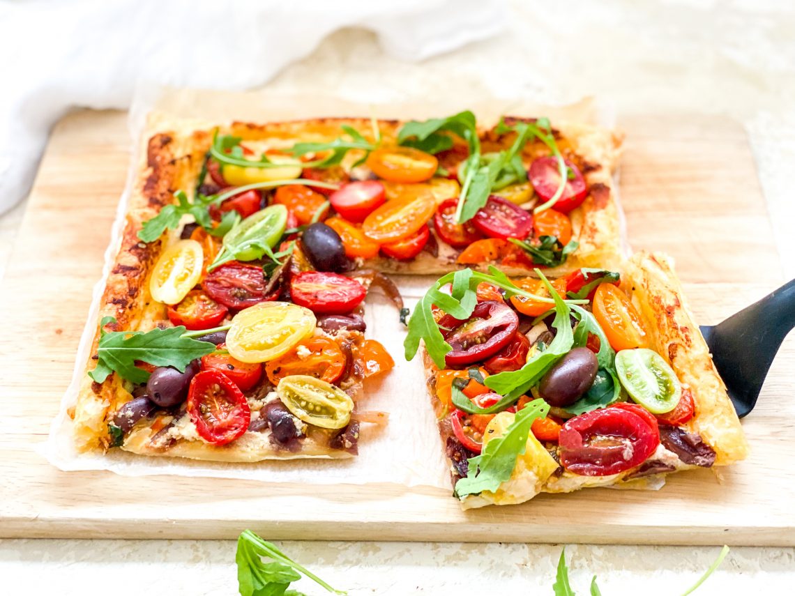 Photograph of Cherry Tomato and Goat's Cheese Tart with Olives, Basil and Rocket