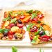 Photograph of Cherry Tomato and Goat's Cheese Tart with Olives, Basil and Rocket