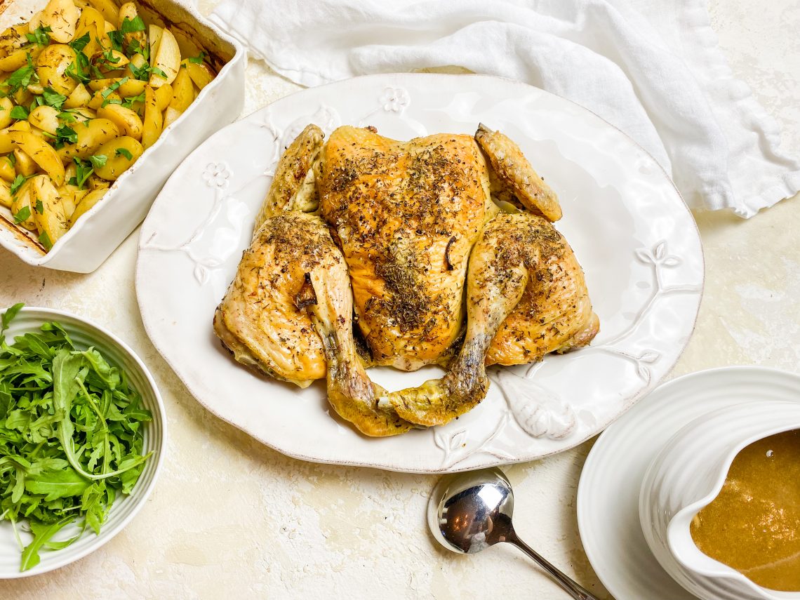 Photograph of Roast Spatchcock Chicken and Gravy with New Potatoes Cooked in Chicken Stock