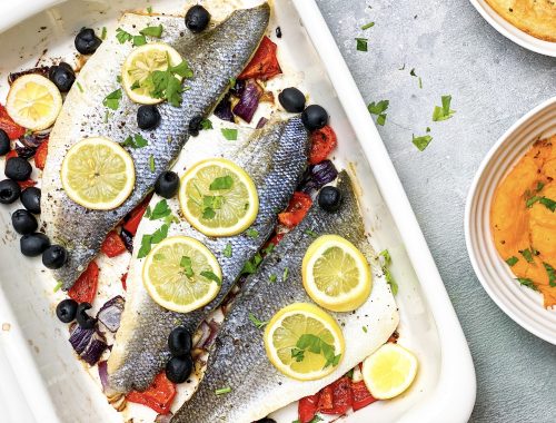 Photograph of Oven-Baked Sea Bass with Red Onion, Red Pepper, Black Olives and Lemon