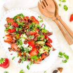 Photograph of Strawberry and Avocado Salad with Burrata, Salted Caramel Pecan Nuts and a Balsamic Dressing with Honey and Poppy Seeds