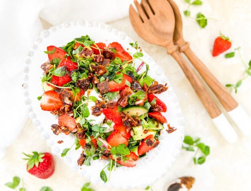 Photograph of Strawberry and Avocado Salad with Burrata, Salted Caramel Pecan Nuts and a Balsamic Dressing with Honey and Poppy Seeds