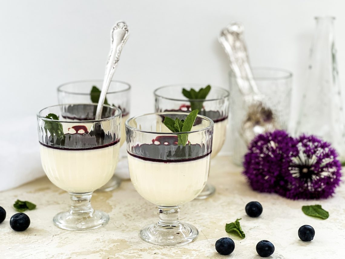 Photograph of White Chocolate Panna Cotta with Blueberry and Blackberry Coulis