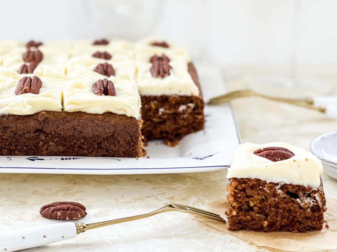 Photograph of Loaded Carrot Cake Slice with a Sweetened Cream Cheese Topping