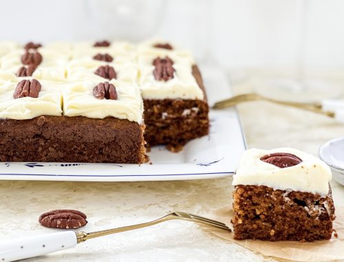 Photograph of Loaded Carrot Cake Slice with a Sweetened Cream Cheese Topping