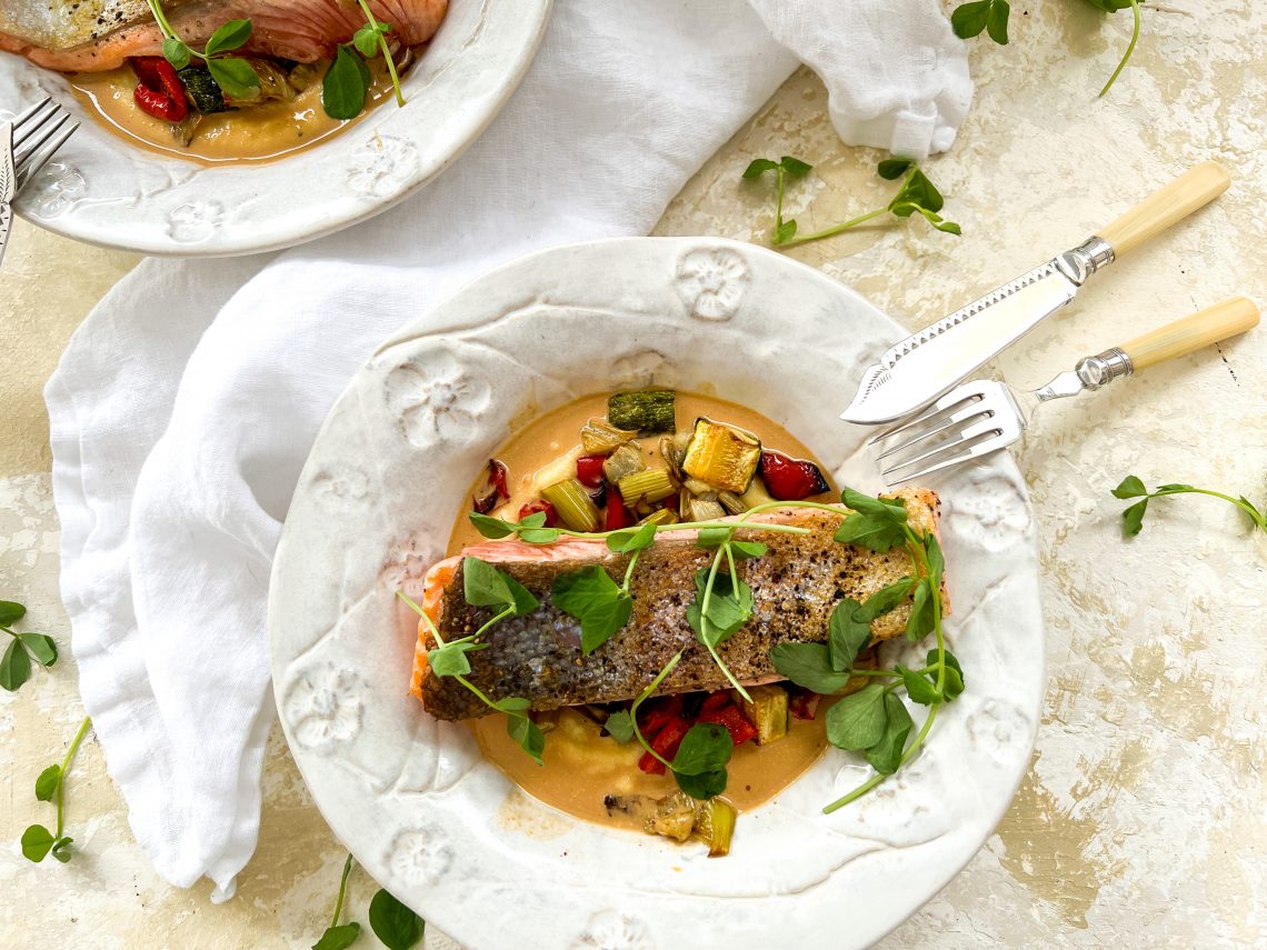 Photograph of Pan-fried Salmon Trout with Creamy Polenta, Roast Vegetables and Prawn Bisque