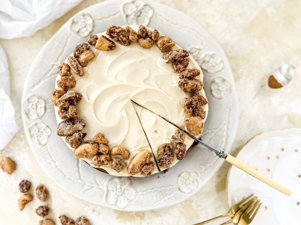 Photograph of Apple Spice Cake with Vanilla and Butter Icing, topped with Cinnamon Candied Nuts