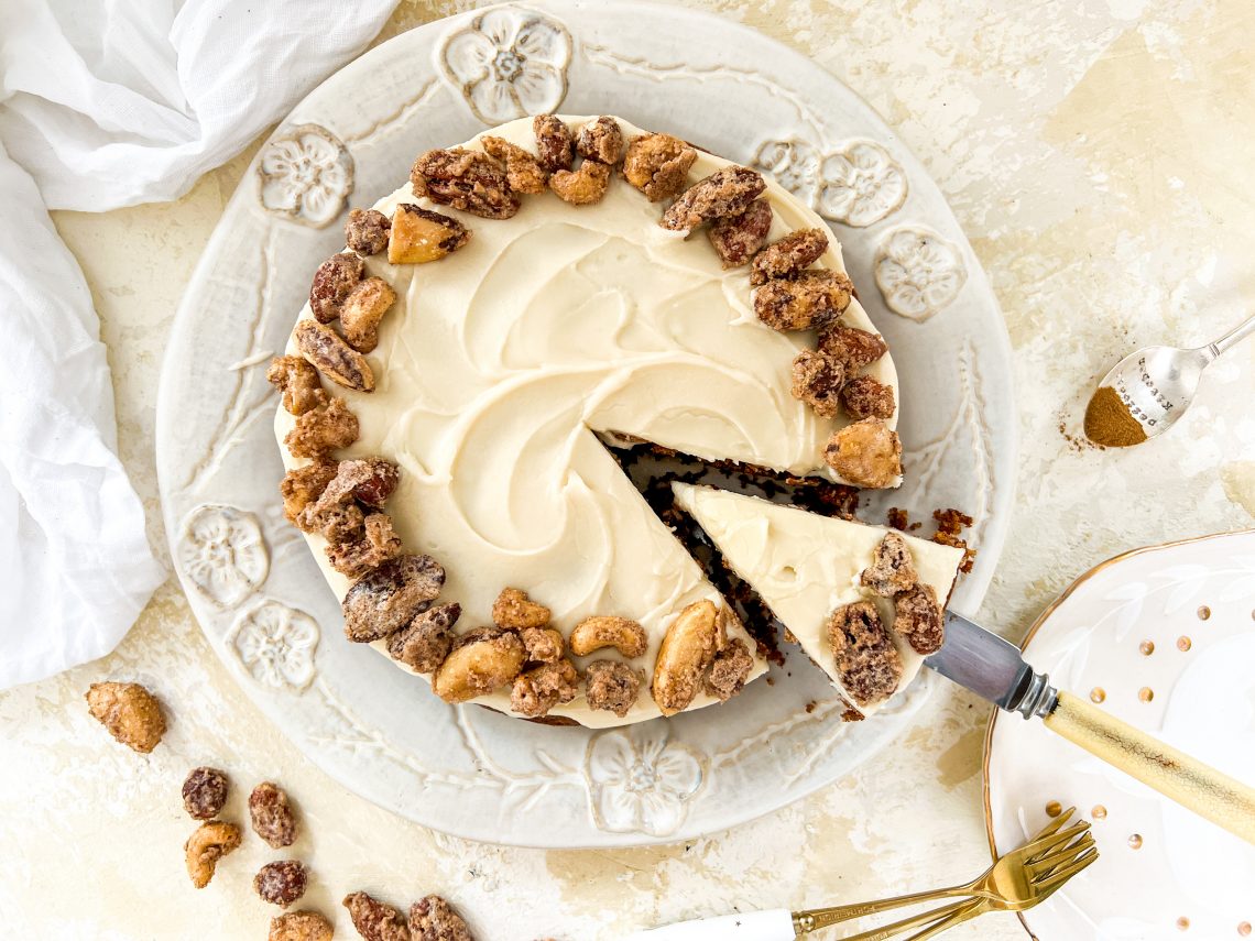 Photograph of Apple Spice Cake with Vanilla and Butter Icing, topped with Cinnamon Candied Nuts