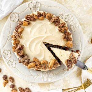 Photograph of Apple Spice Cake with Vanilla and Butter Icing, topped with Cinnamon Candied Nuts