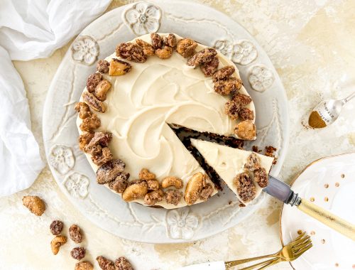 Photograph of Apple Spice Cake with Vanilla and Butter Icing, topped with Cinnamon Candied Nuts