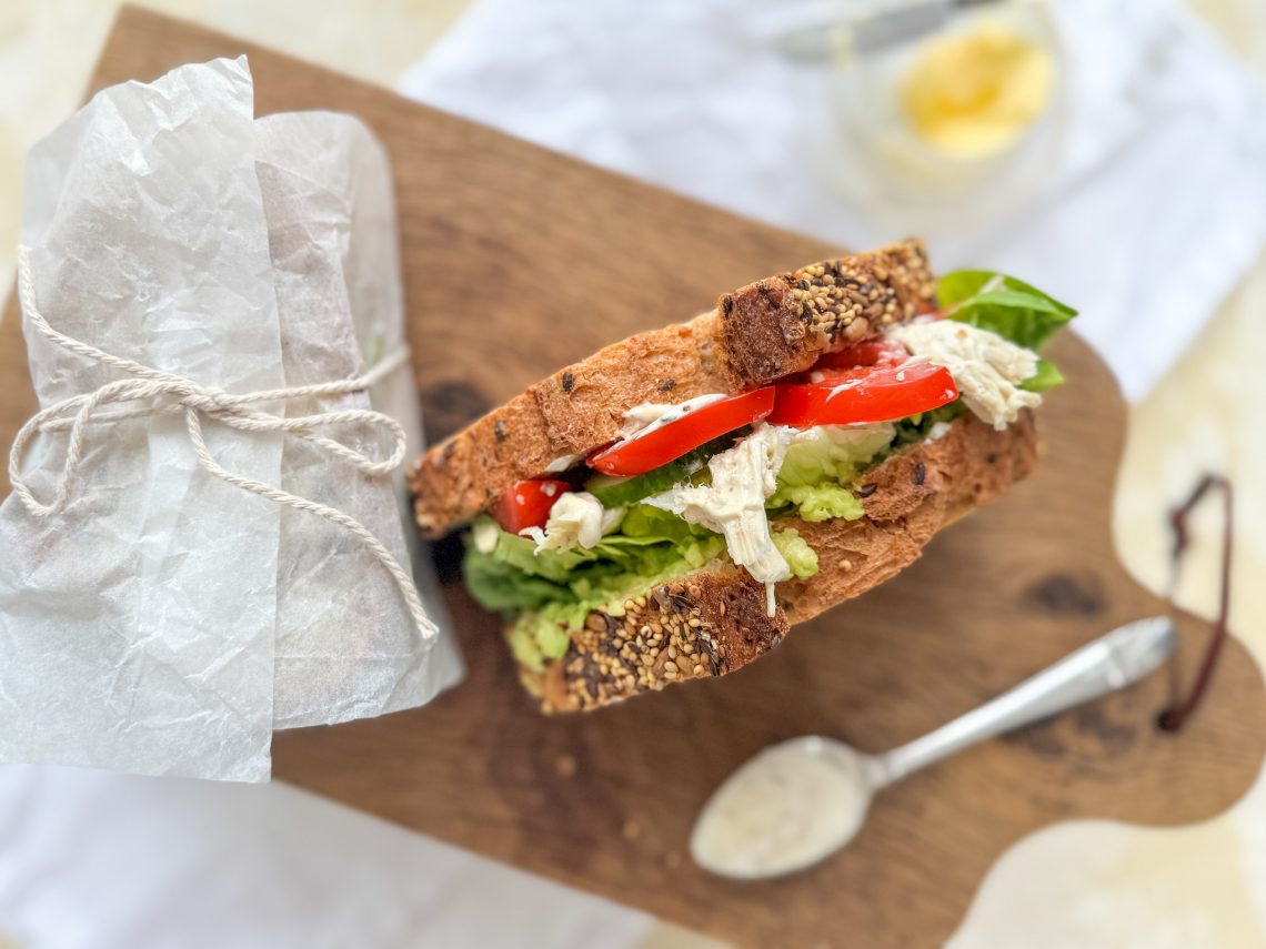 Photograph of Taid's Chicken Butty with Avocado, Lettuce, Tomato Cucumber and a Yoghurt, Mustard Dressing